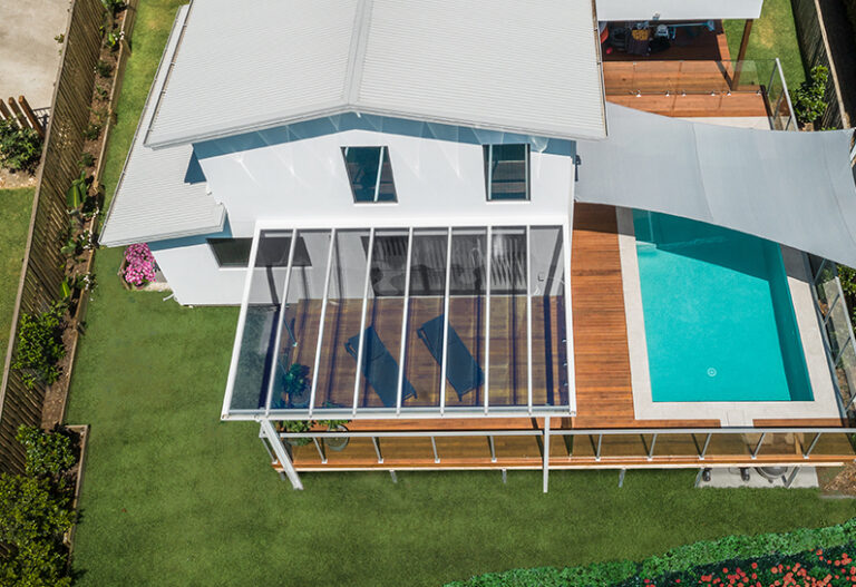 Poolside pergola covered with SUNSCAPE roofing panels